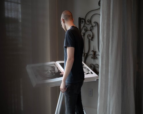Man adjusting monitor height for ergonomics